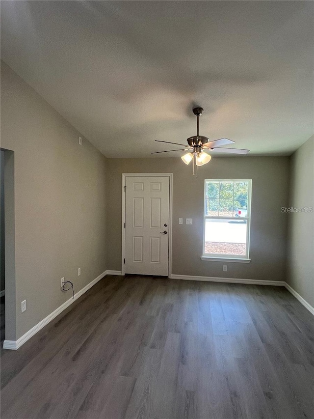 spare room featuring ceiling fan and dark hardwood / wood-style flooring