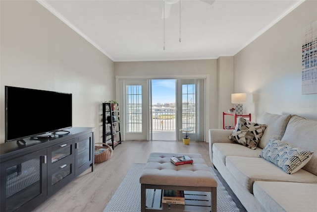 living room with ceiling fan, ornamental molding, and light hardwood / wood-style floors