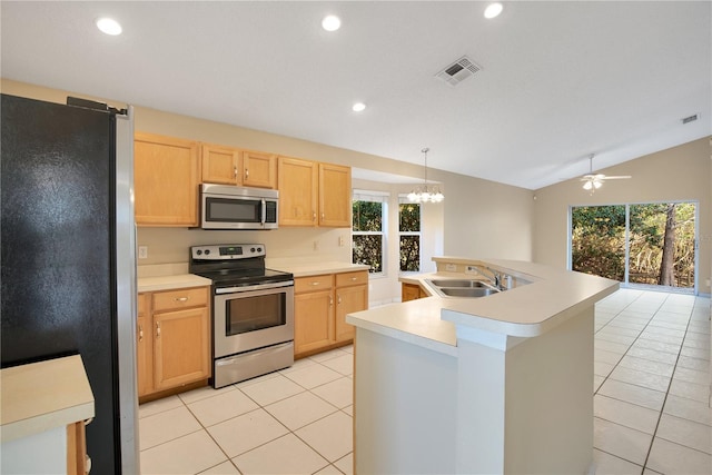 kitchen with sink, stainless steel appliances, a center island with sink, light brown cabinetry, and decorative light fixtures