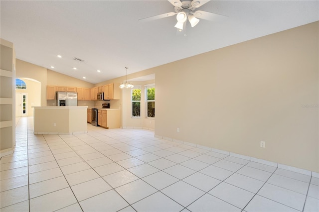 unfurnished living room with lofted ceiling, ceiling fan with notable chandelier, and light tile patterned floors