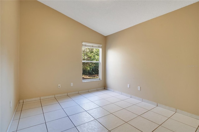 tiled empty room with vaulted ceiling