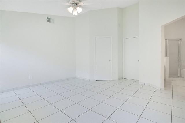 spare room with light tile patterned floors, a ceiling fan, and visible vents