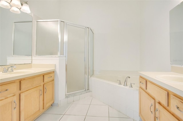 full bathroom featuring two vanities, a bath, tile patterned flooring, a sink, and a stall shower