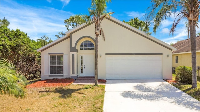 view of front of house featuring driveway, stucco siding, and a garage