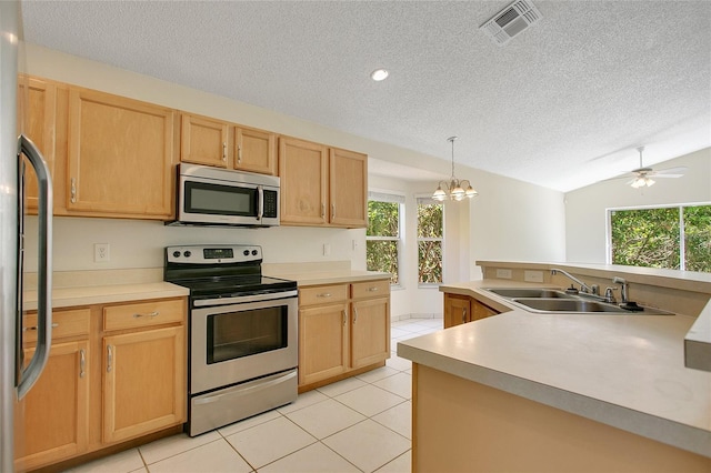 kitchen featuring visible vents, light tile patterned floors, a sink, appliances with stainless steel finishes, and a textured ceiling