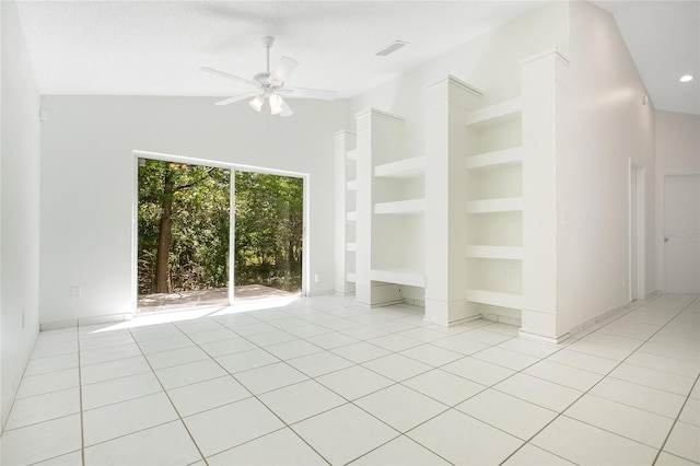 unfurnished room with lofted ceiling, visible vents, light tile patterned flooring, and ceiling fan