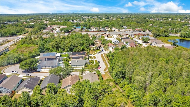 drone / aerial view with a water view and a residential view