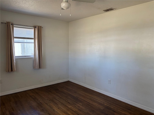 unfurnished room featuring ceiling fan, a textured ceiling, and dark hardwood / wood-style flooring