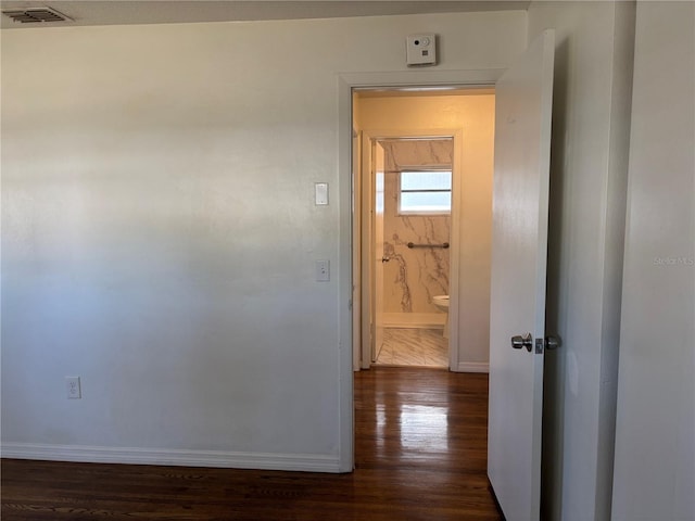 corridor with dark hardwood / wood-style floors