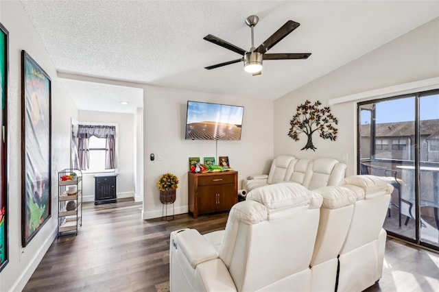 living room with dark hardwood / wood-style flooring, a textured ceiling, vaulted ceiling, and ceiling fan