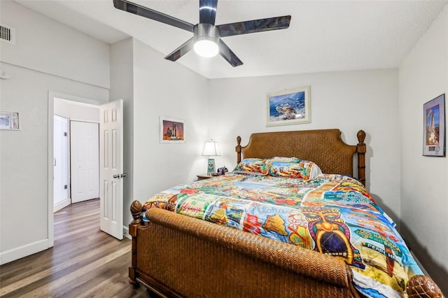 bedroom featuring hardwood / wood-style flooring, ceiling fan, and vaulted ceiling