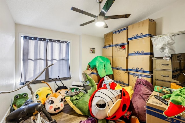 playroom featuring wood-type flooring and ceiling fan