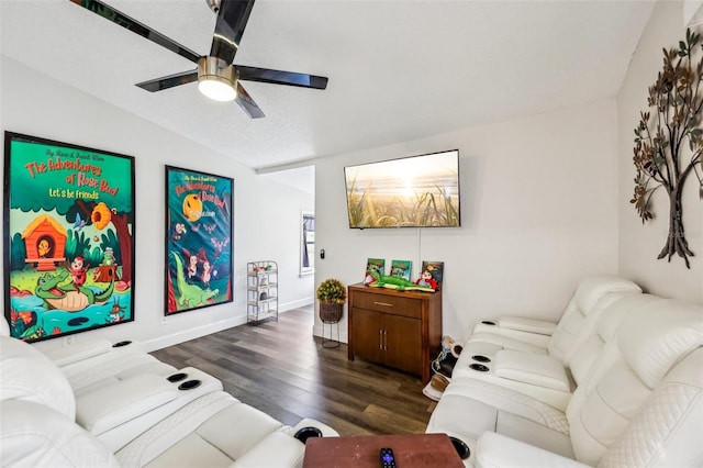 living room with ceiling fan, dark wood-type flooring, vaulted ceiling, and a textured ceiling