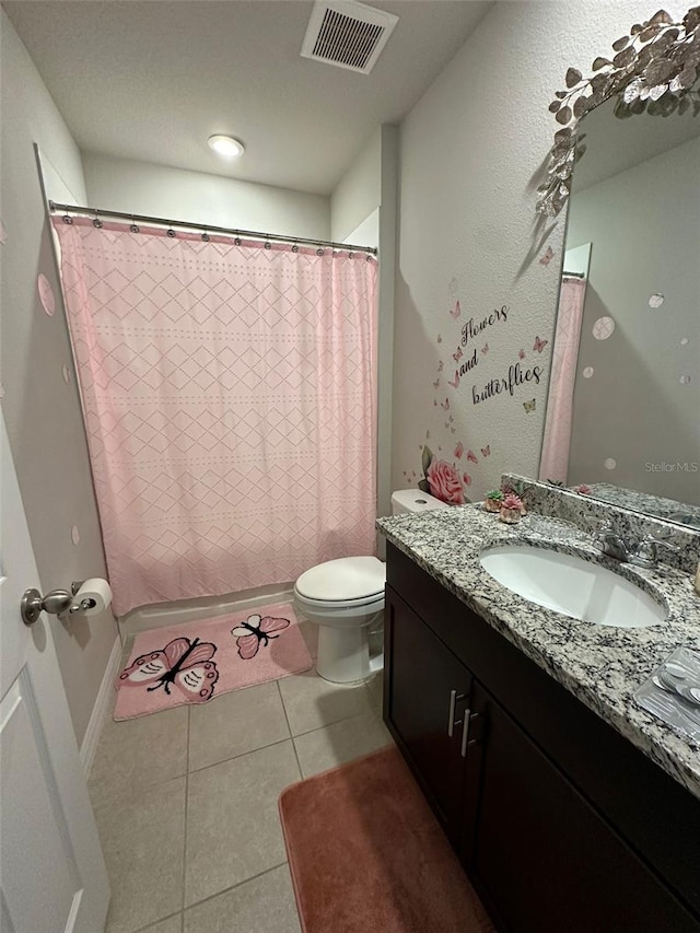 full bathroom featuring toilet, vanity, visible vents, and tile patterned floors