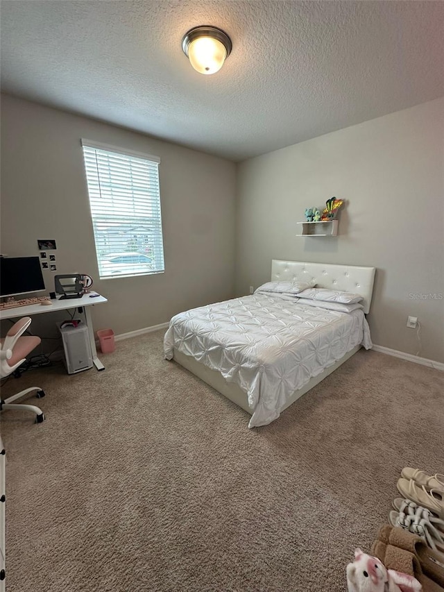 bedroom featuring a textured ceiling, carpet, and baseboards