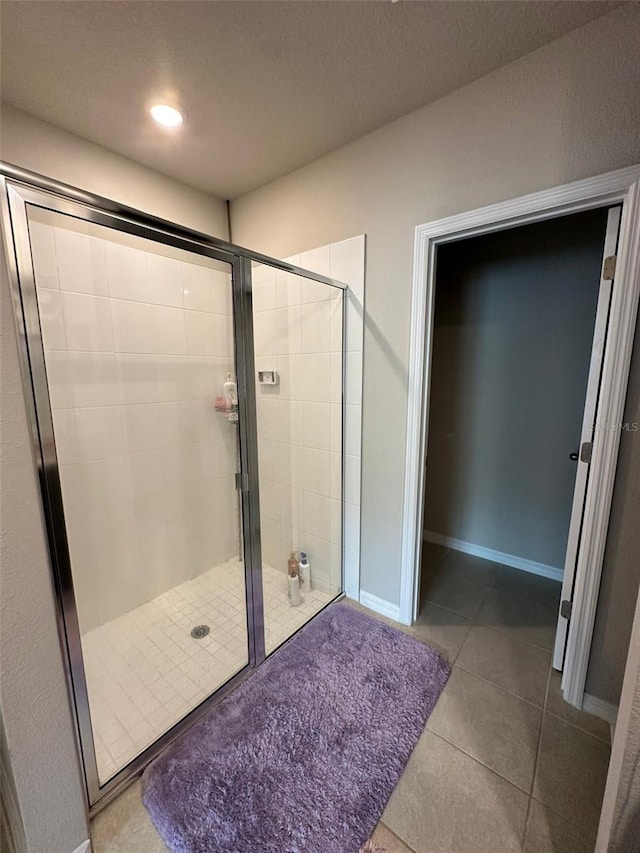 full bath featuring a shower stall, baseboards, tile patterned flooring, and recessed lighting