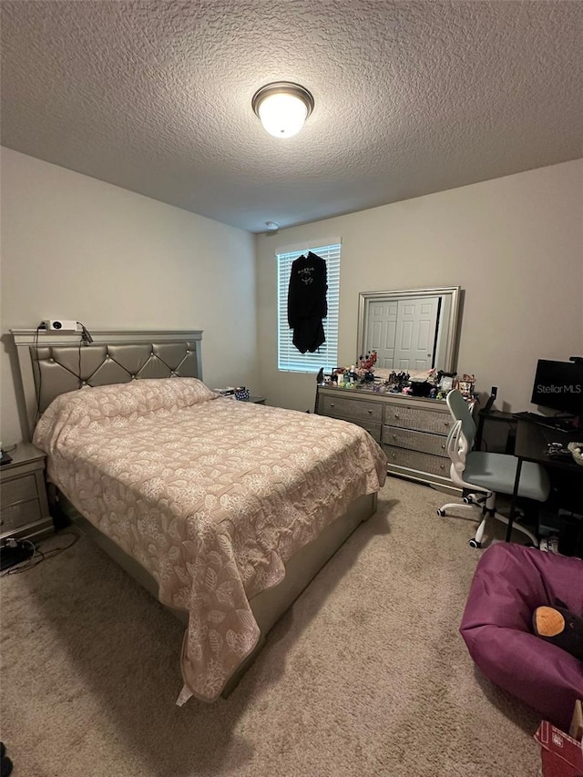 carpeted bedroom with a textured ceiling