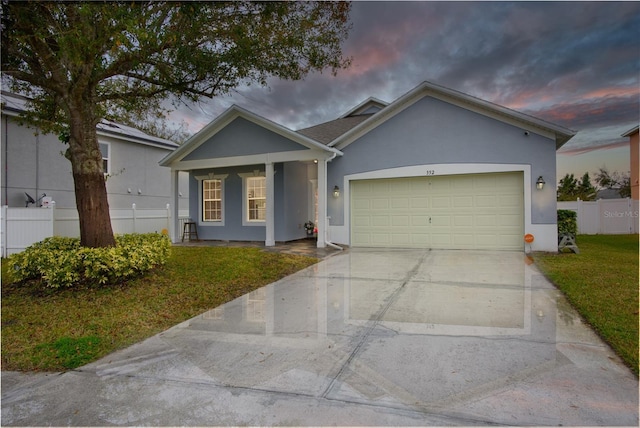 view of front facade featuring a garage and a lawn