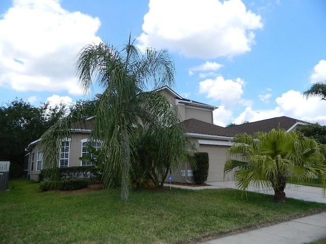 view of front of home featuring a garage and a front lawn