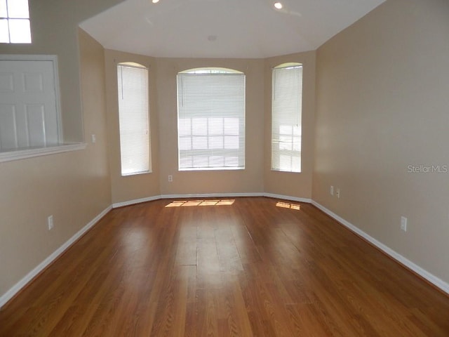 unfurnished room with wood-type flooring