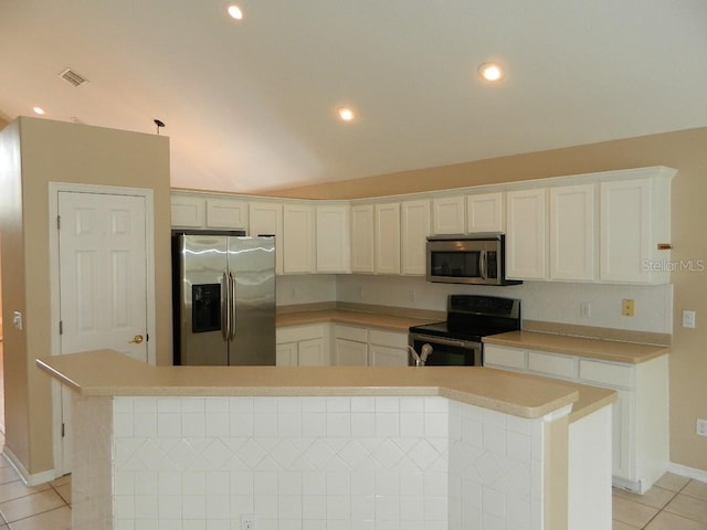 kitchen with light tile patterned flooring, white cabinetry, lofted ceiling, a center island, and stainless steel appliances