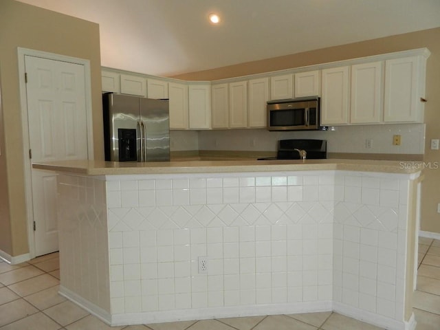 kitchen with light tile patterned floors, stainless steel appliances, and white cabinets