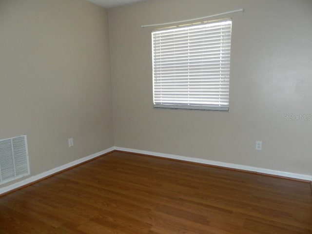 unfurnished room with hardwood / wood-style flooring