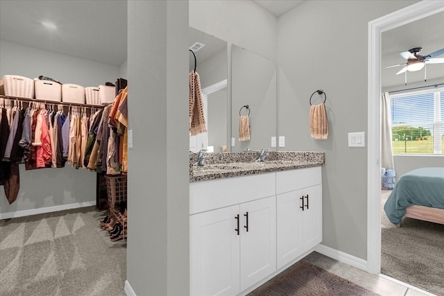 bathroom featuring ceiling fan and vanity