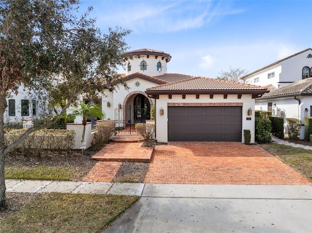 mediterranean / spanish-style home with a garage