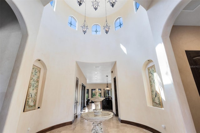 hallway featuring a towering ceiling