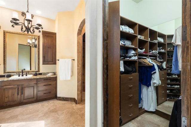 bathroom with vanity and an inviting chandelier