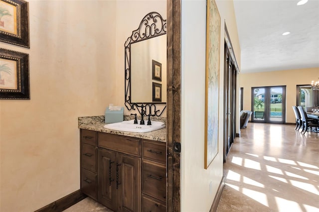 interior space with an inviting chandelier, sink, and french doors