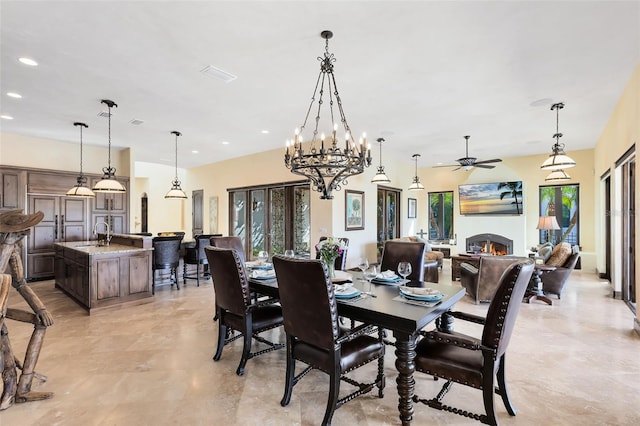 dining space with sink, a wealth of natural light, and ceiling fan