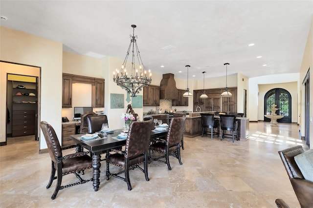 dining area with a notable chandelier and french doors