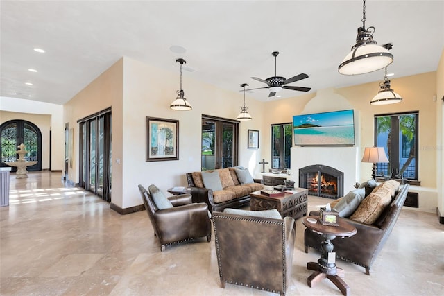 living room featuring ceiling fan and french doors