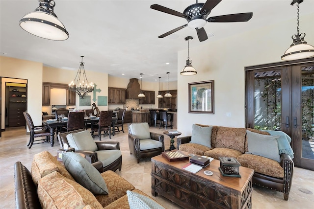 living room with ceiling fan with notable chandelier and french doors