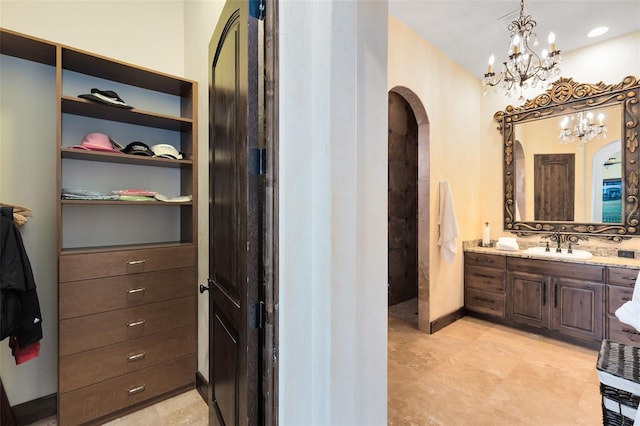 bathroom featuring vanity and a chandelier