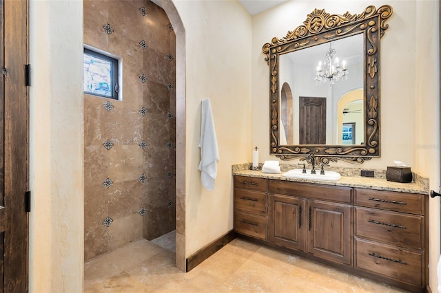 bathroom with vanity and tiled shower