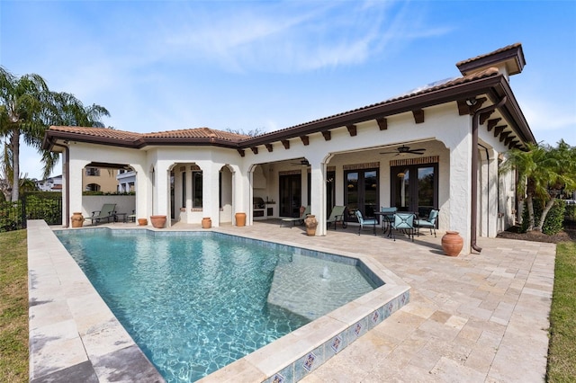 back of house with a fenced in pool, a patio area, ceiling fan, and french doors