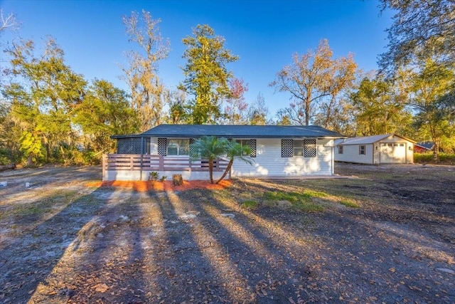 single story home featuring an outbuilding