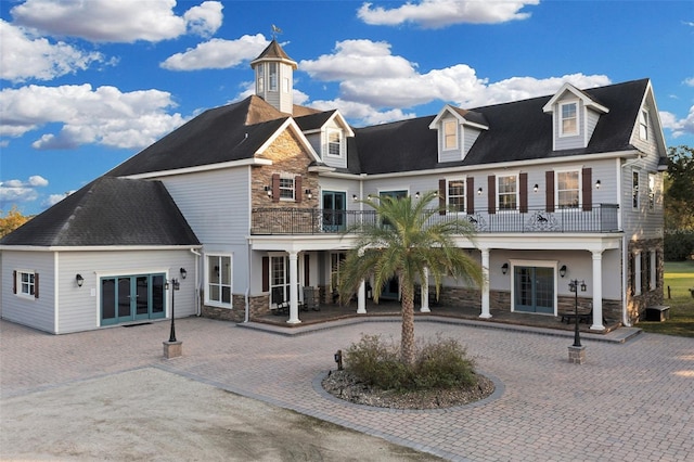 back of property featuring a balcony