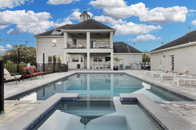 view of swimming pool with an in ground hot tub, ceiling fan, grilling area, and a patio