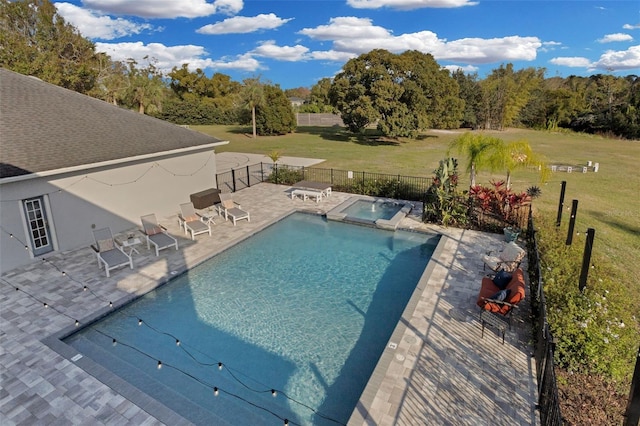 view of swimming pool with an in ground hot tub, a yard, and a patio area