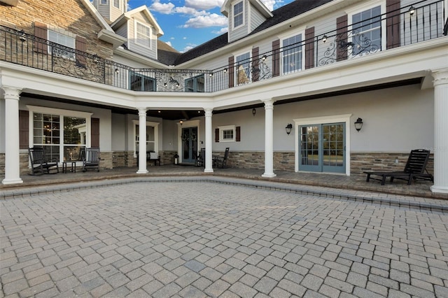 rear view of property with a balcony