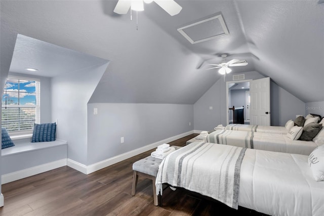 bedroom featuring dark wood-type flooring, ceiling fan, vaulted ceiling, and a textured ceiling