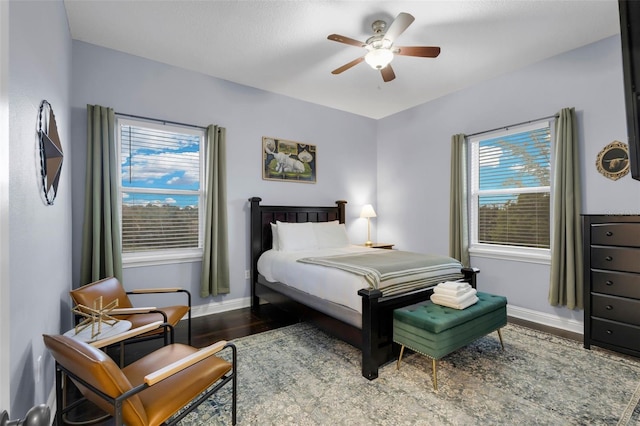 bedroom with ceiling fan and wood-type flooring