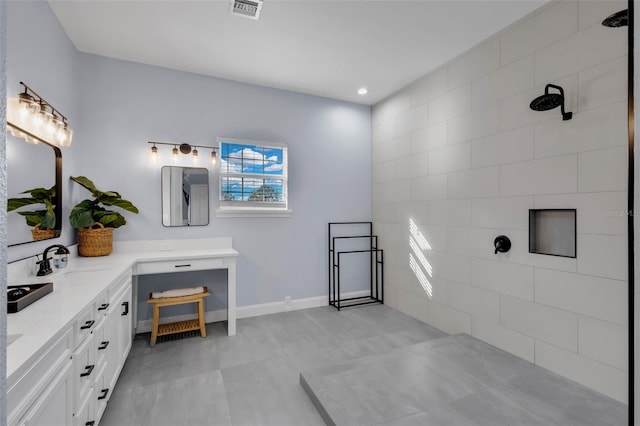 bathroom featuring vanity and a shower