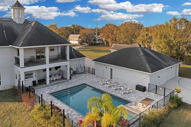 view of pool with a patio area and a lawn