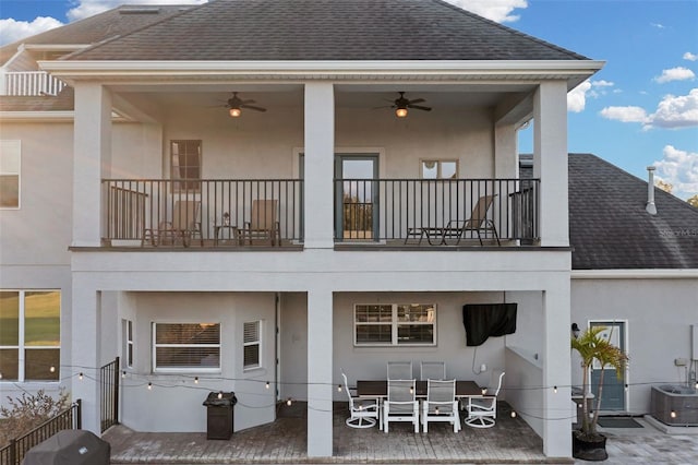 rear view of property featuring ceiling fan, central AC unit, a patio area, and a balcony