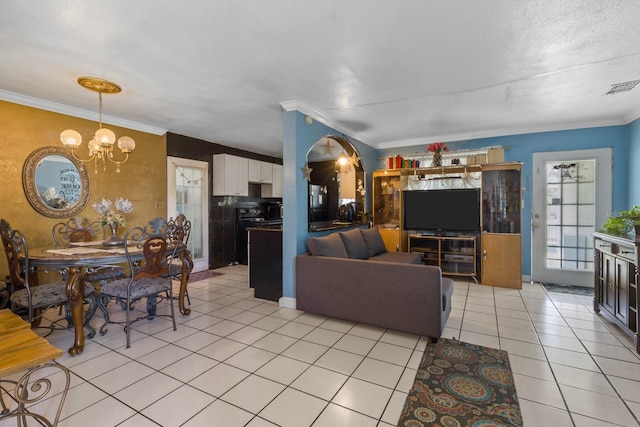 living room with crown molding, light tile patterned floors, and a chandelier